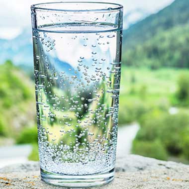 Un bicchiere di acqua potabile sottolinea l'importanza del monitoraggio di nitrati e nitriti nell'acqua potabile, che possono causare gravi problemi di salute.